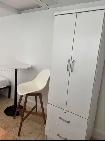 a view of a room with a table and chairs