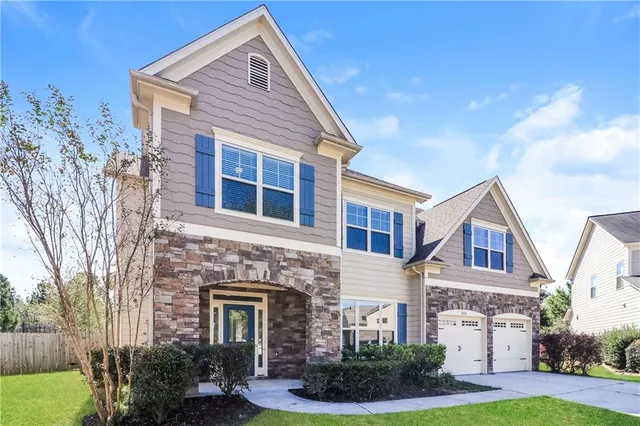 a front view of a house with garden