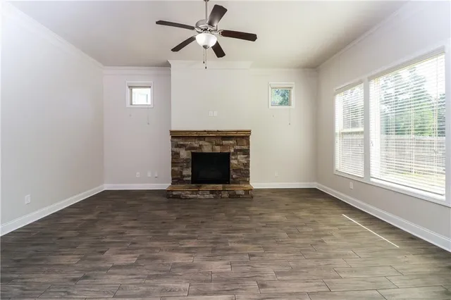 a view of empty room with a fireplace and a window