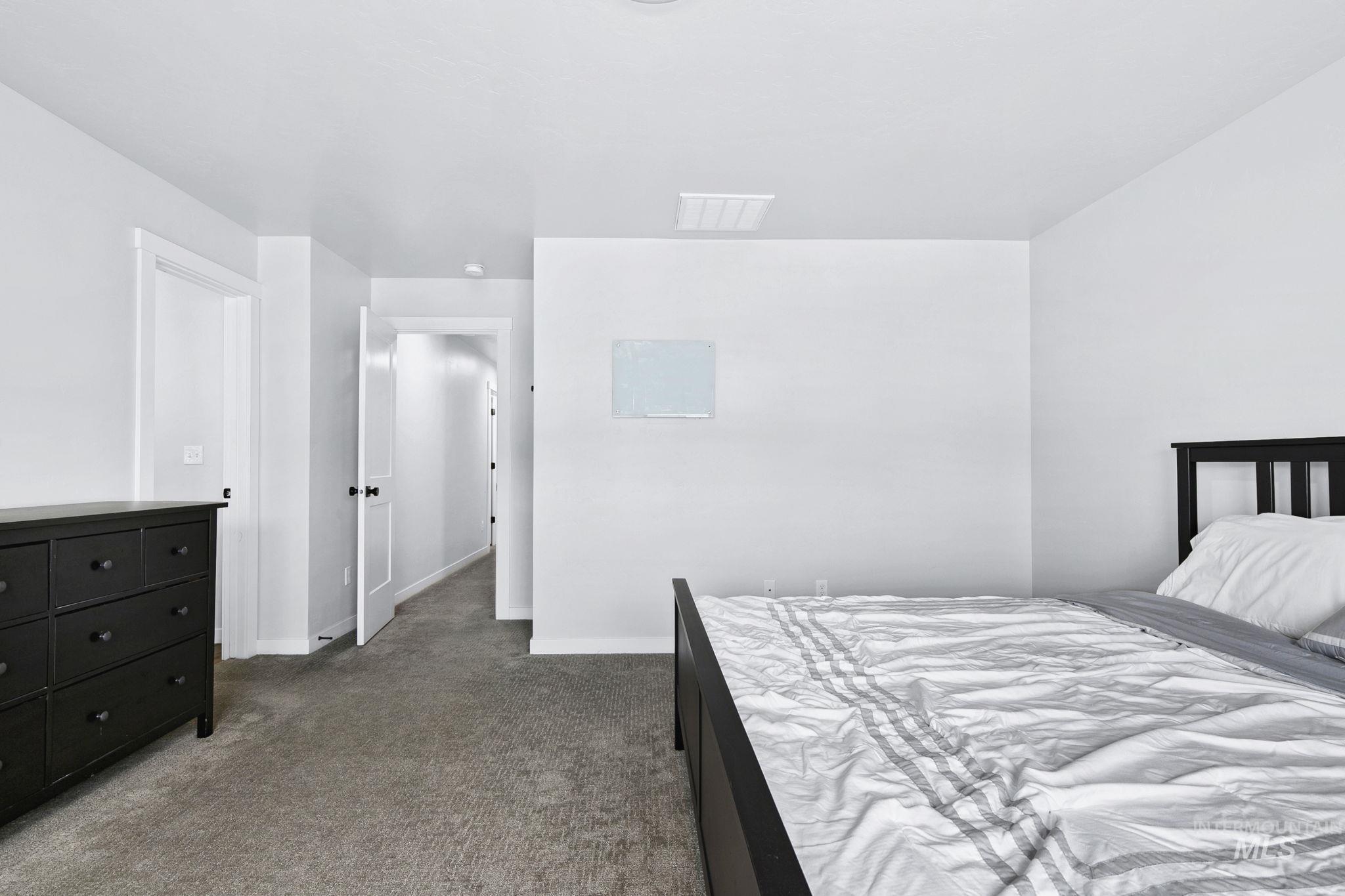 298 South Fritts Avenue Meridian, ID 83642 - Photo 17 of 32 Bedroom featuring dark colored carpet and baseboards
