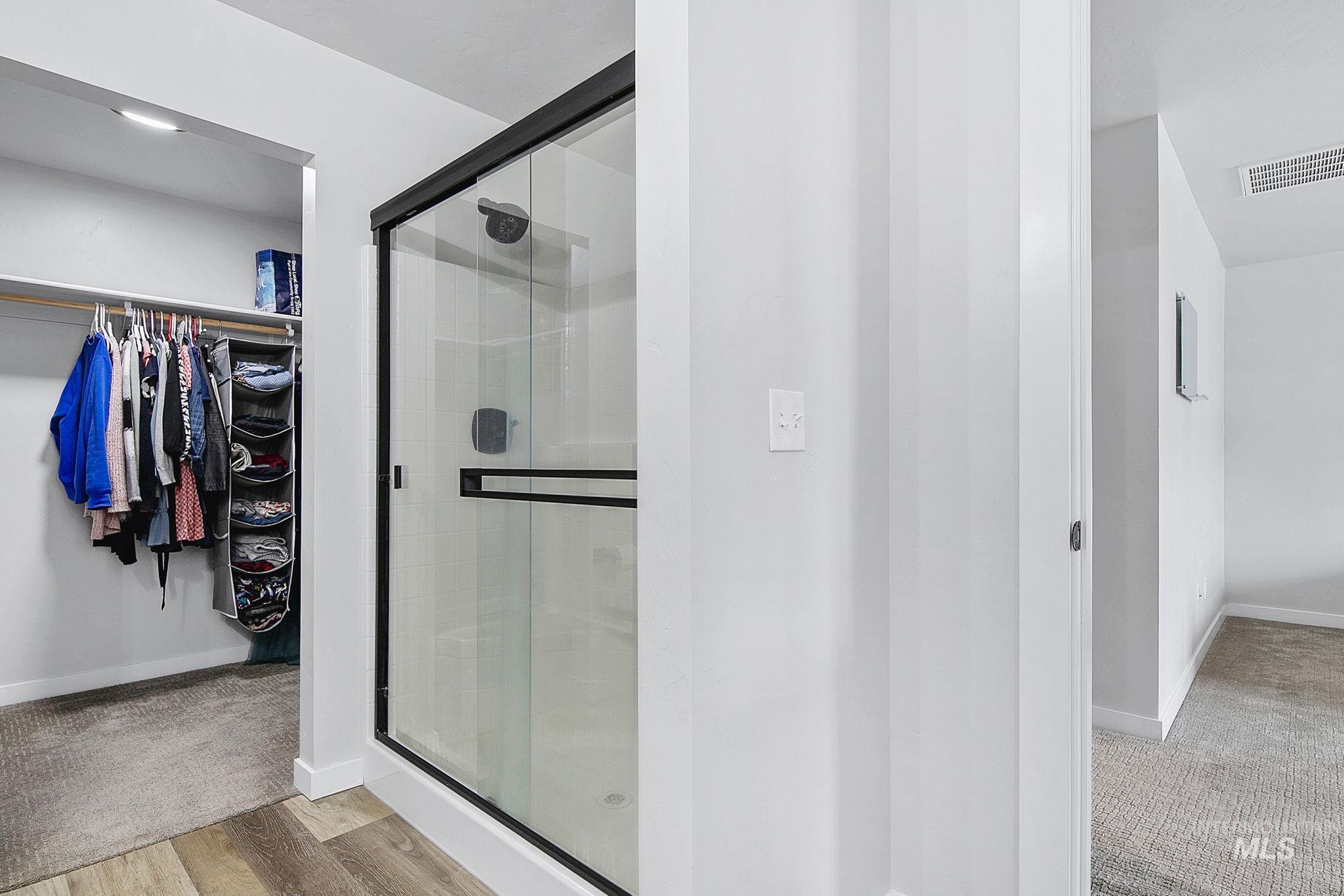 298 South Fritts Avenue Meridian, ID 83642 - Photo 19 of 32 Full bathroom featuring a spacious closet, a stall shower, and light wood-style floors