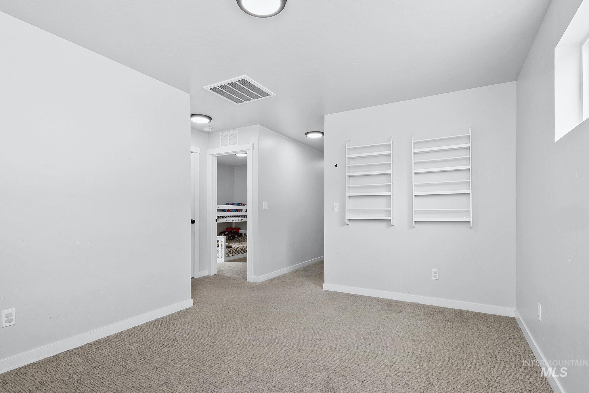 298 South Fritts Avenue Meridian, ID 83642 - Photo 22 of 32 Empty room with light carpet and baseboards