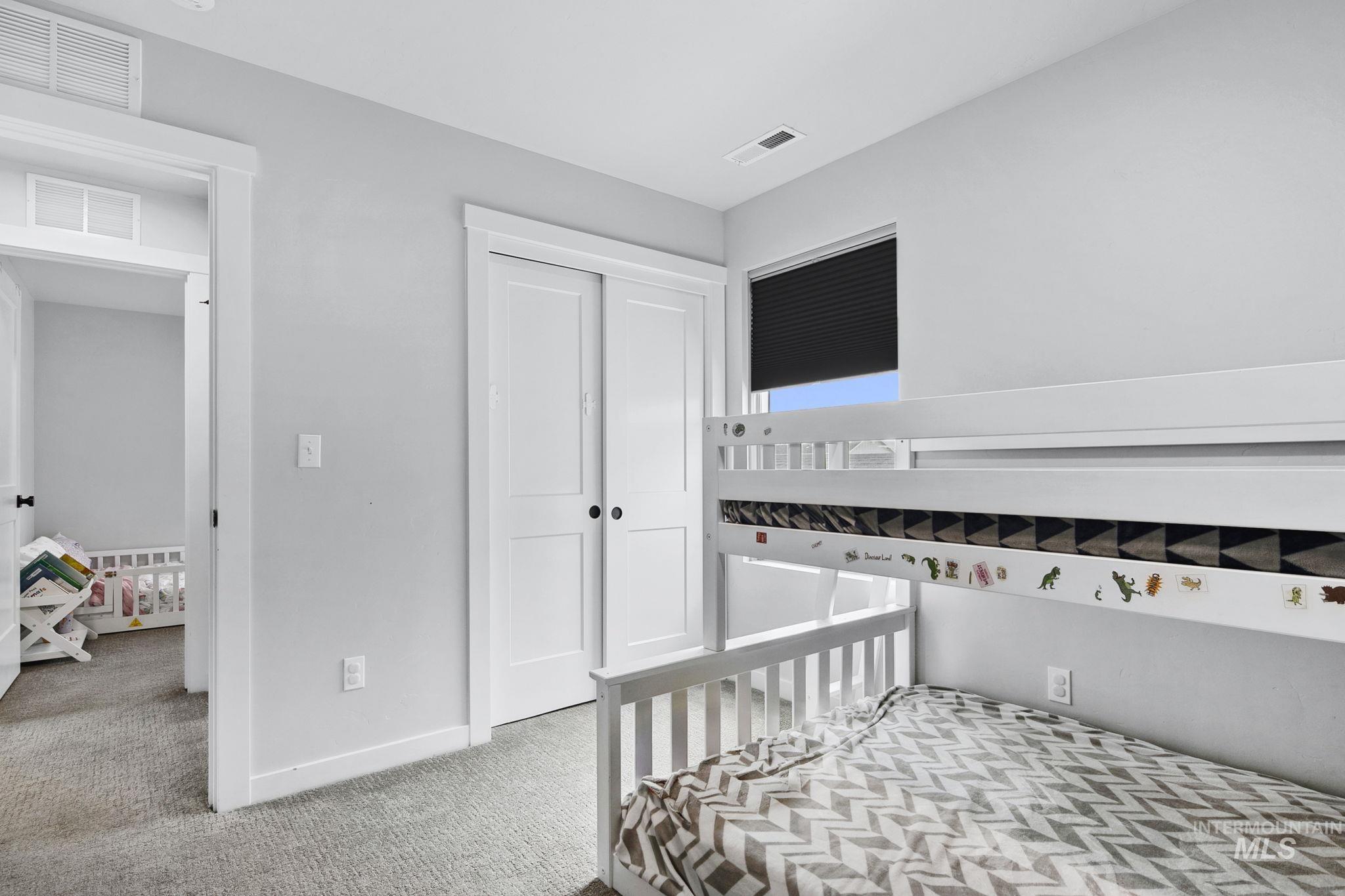 298 South Fritts Avenue Meridian, ID 83642 - Photo 24 of 32 Bedroom with light colored carpet and a closet