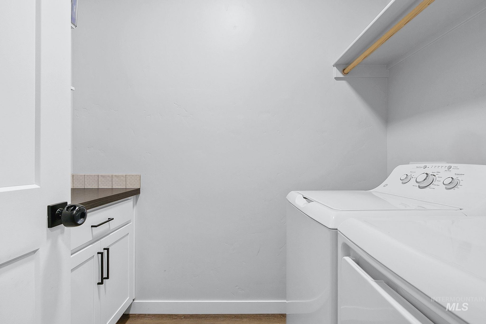 298 South Fritts Avenue Meridian, ID 83642 - Photo 27 of 32 Laundry room with washing machine and clothes dryer and cabinet space
