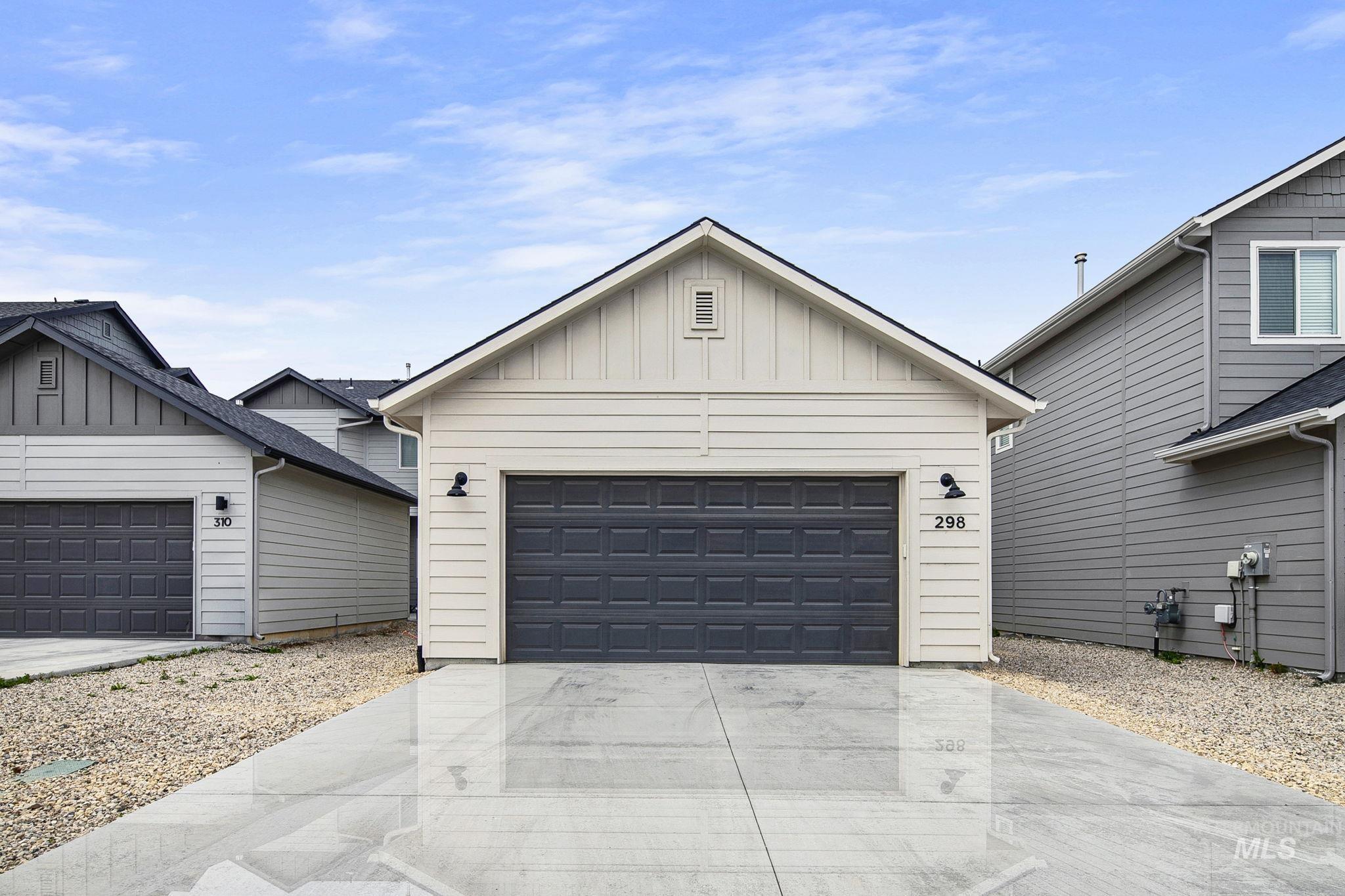 298 South Fritts Avenue Meridian, ID 83642 - Photo 29 of 32 View of front of home featuring board and batten siding, a garage, and concrete driveway