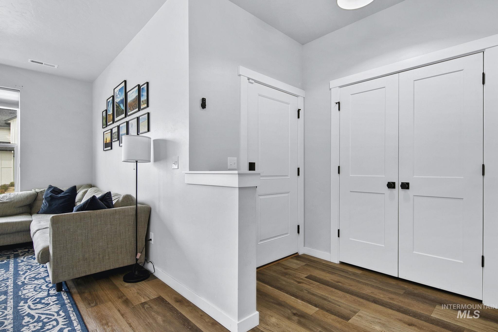 298 South Fritts Avenue Meridian, ID 83642 - Photo 3 of 32 Hallway featuring baseboards and dark wood-style flooring