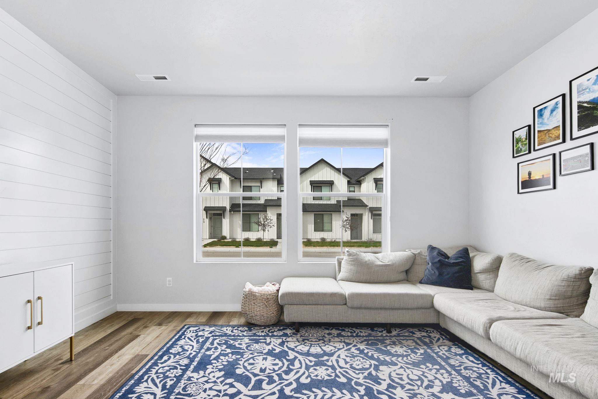 298 South Fritts Avenue Meridian, ID 83642 - Photo 4 of 32 Living area featuring wood finished floors and wood walls