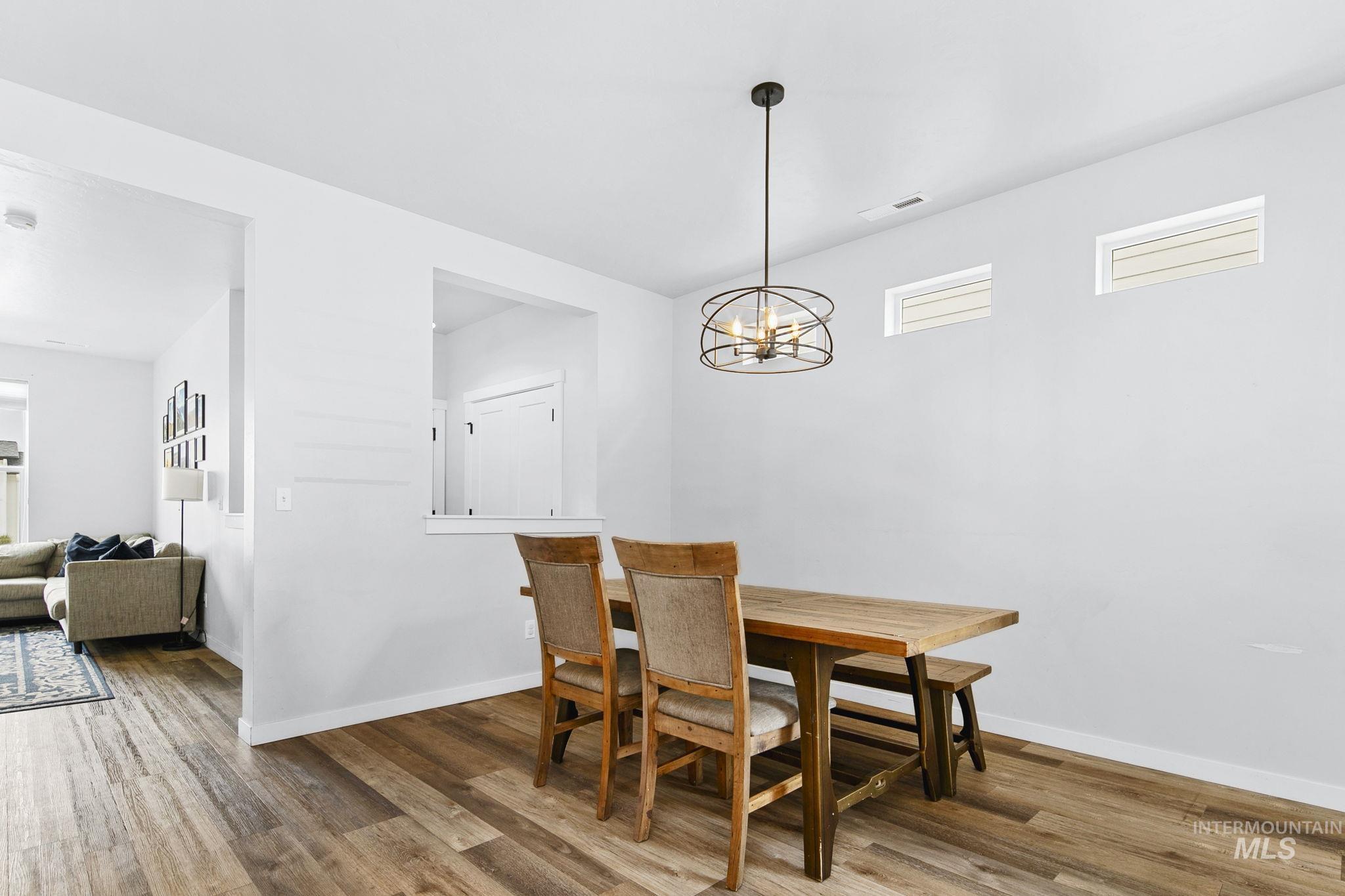 298 South Fritts Avenue Meridian, ID 83642 - Photo 7 of 32 Dining room with wood finished floors and a chandelier