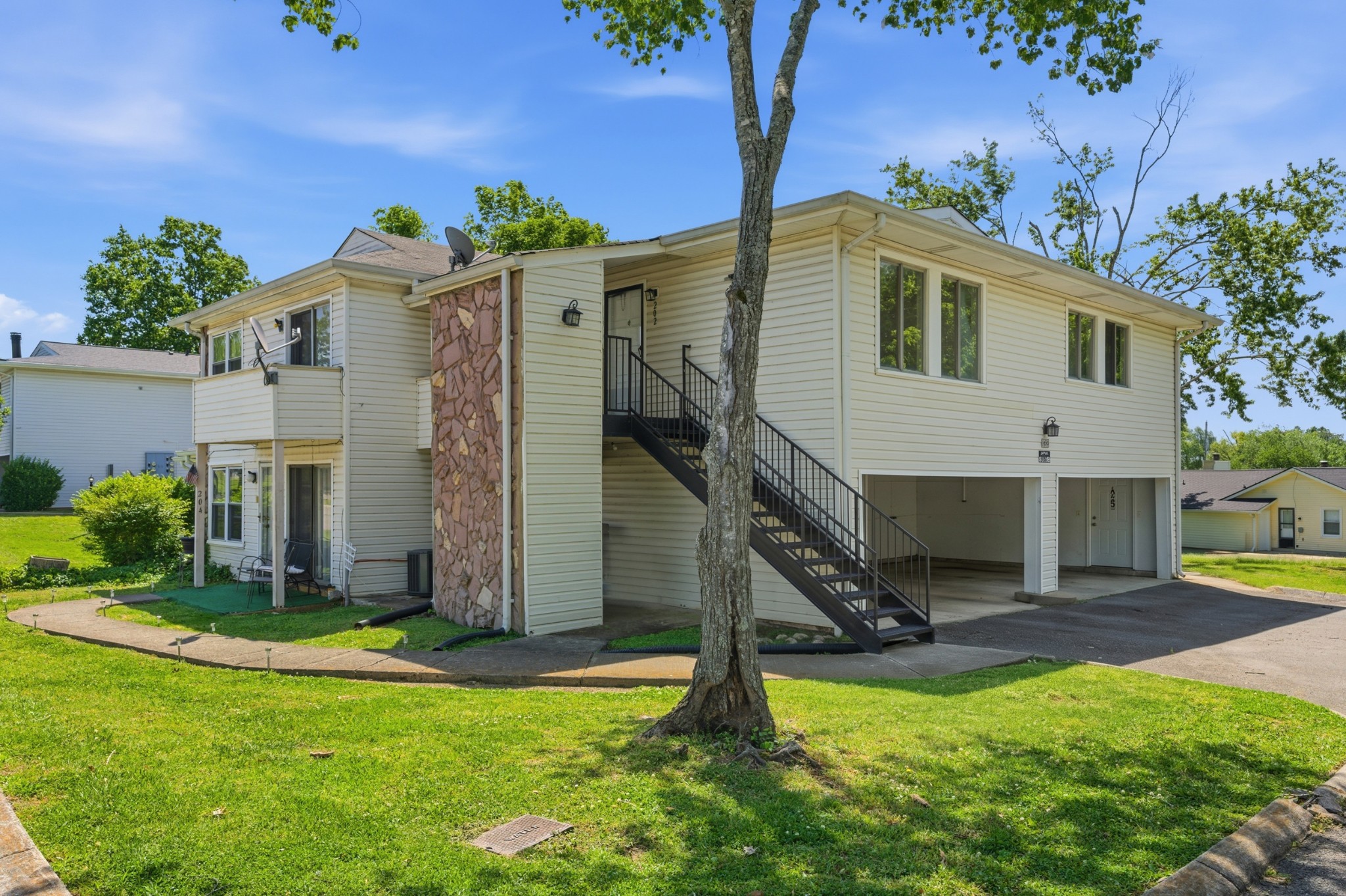 810 Bellevue Road, Unit 202 Nashville, TN 37221 - Photo 1 of 17 a view of a house with backyard and a tree