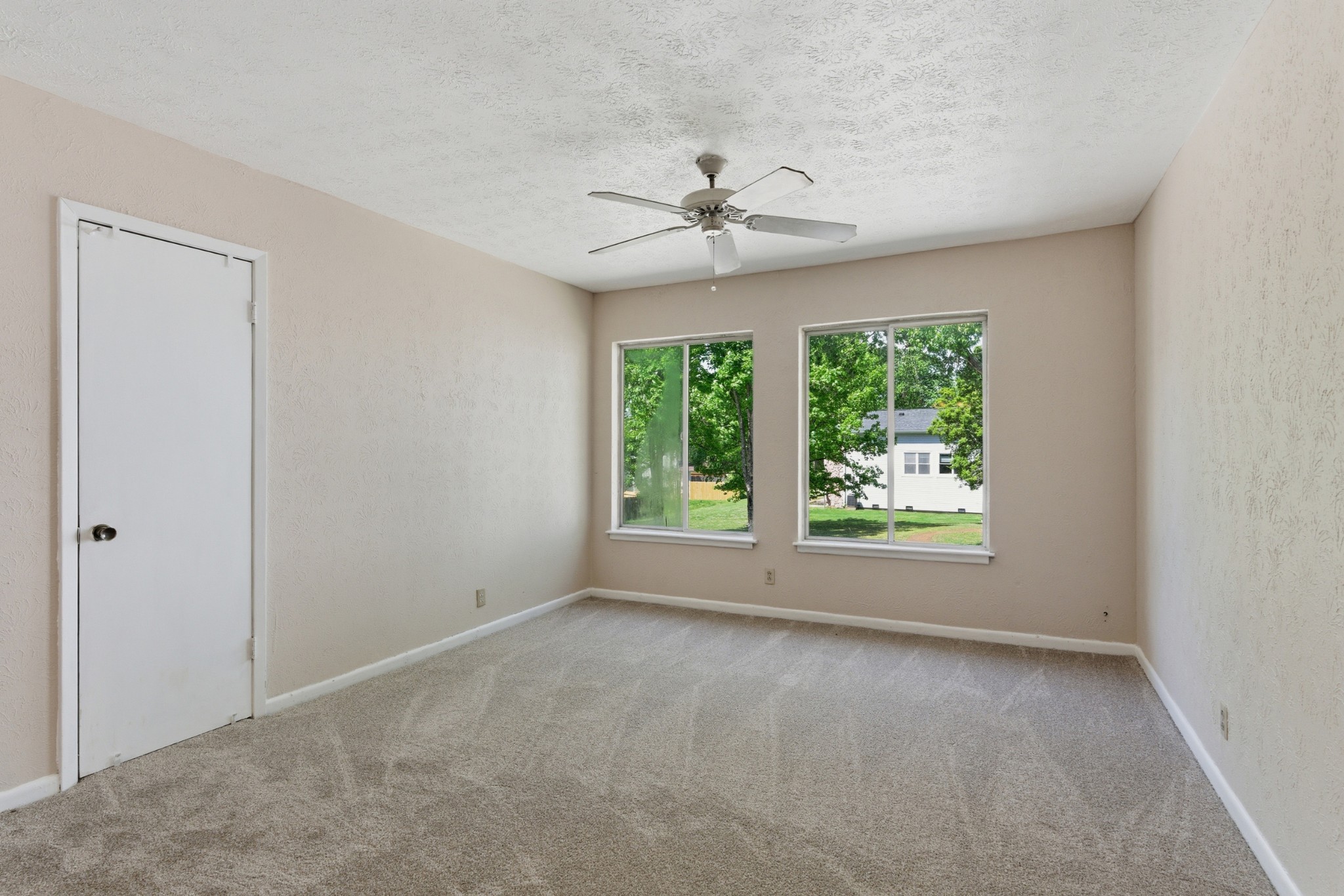 810 Bellevue Road, Unit 202 Nashville, TN 37221 - Photo 7 of 17 an empty room with a ceiling fan and windows