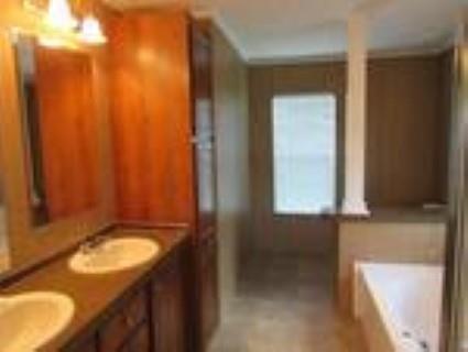 93 Harbin Road Fayetteville, TN 37334 - Photo 3 of 9 a bathroom with a granite countertop sink and a mirror