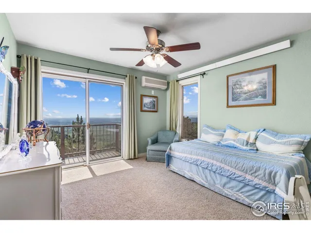 a bedroom with a bed and a large mirror