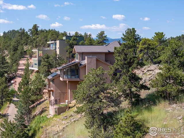 an aerial view of a house with a yard and lake view