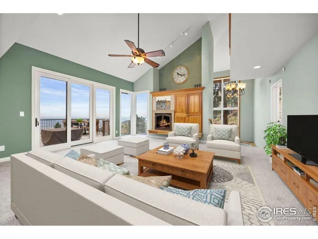 a living room with furniture a flat screen tv and a table