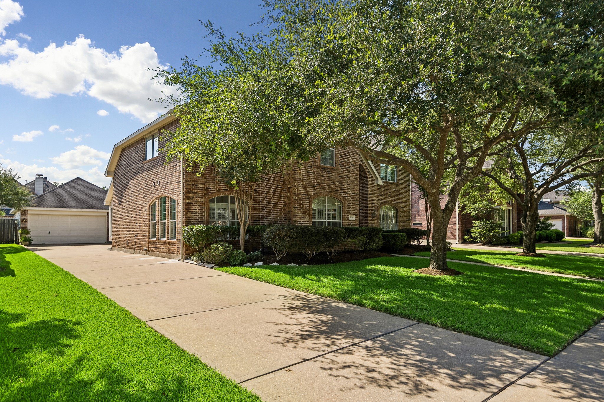 5718 Brennan Ridge Lane Katy, TX 77450 - Photo 35 of 42 OVERSIZED GARAGE WITH ROOM FOR IT ALL: An extended driveway leads to an oversized detached garage featuring a rare 12-foot rear extension and 7-foot side extension, offering exceptional space for vehicles, storage, hobbies, or a workshop.