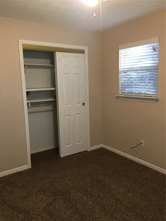 a view of an empty room with a closet