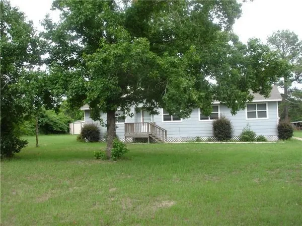 a view of a house with a yard and sitting area