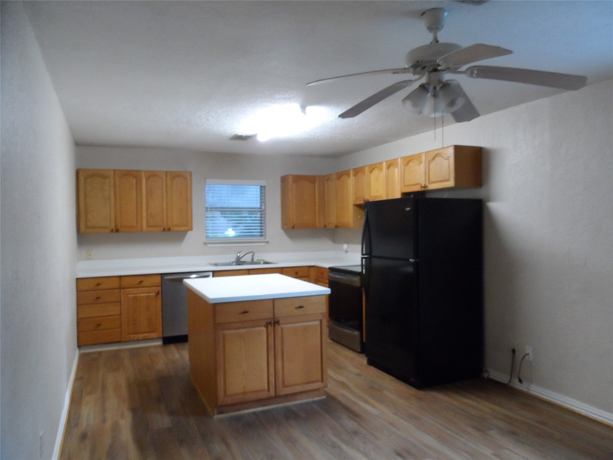 2283 McCaleb Road Montgomery, TX 77316 - Photo 29 of 45 a kitchen with a sink a refrigerator and cabinets