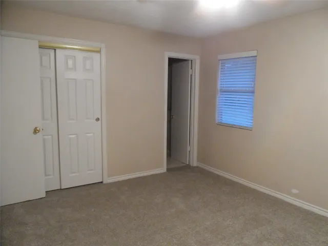 an empty room with a empty space and windows