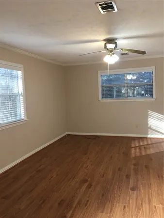a view of a room with wooden floor