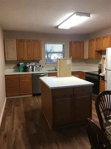 a kitchen with sink cabinets and window