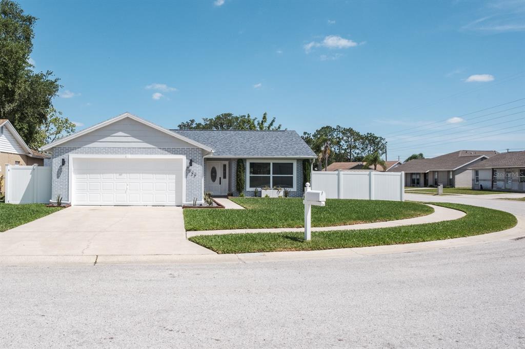 7923 Griswold Loop New Port Richey, FL 34655 - Photo 1 of 1 a front view of a house with a yard and garage
