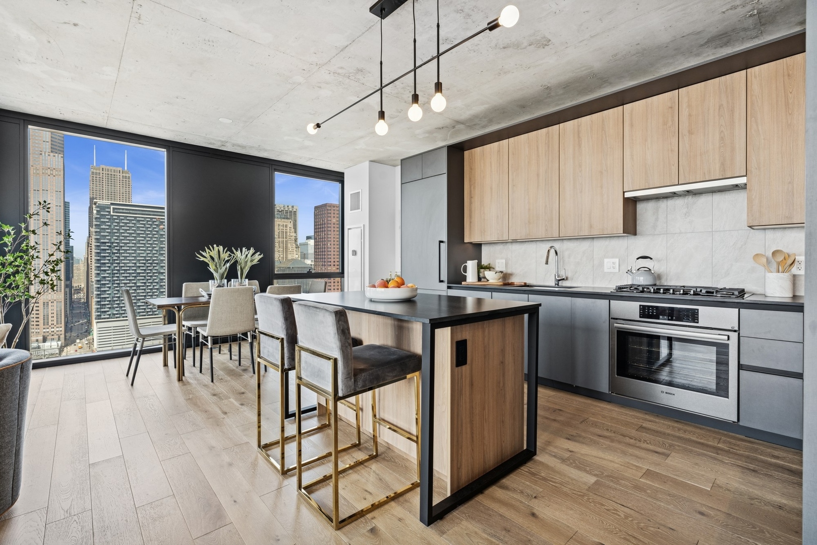 234 West Polk Street, Unit 2802 Chicago, IL 60605 - Photo 10 of 39 a kitchen with stainless steel appliances granite countertop a stove top oven a sink dishwasher a dining table and chairs with wooden floor