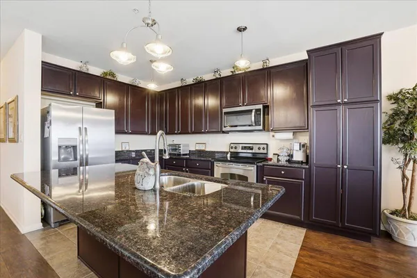 a living room with furniture a flat screen tv and wooden floor