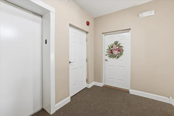 a view of a hallway with paintings on the wall