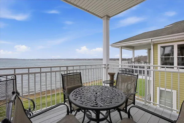 a view of a balcony with chair and wooden floor