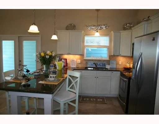 a kitchen with sink and refrigerator