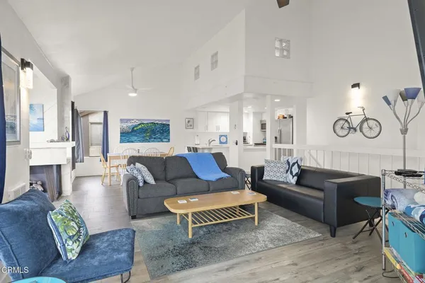 a living room with furniture fireplace and a large window
