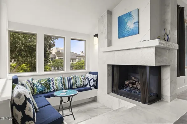 a white couch sitting in front of a window