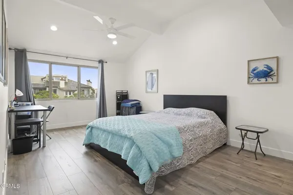 a bedroom with a bed and painting on the wall