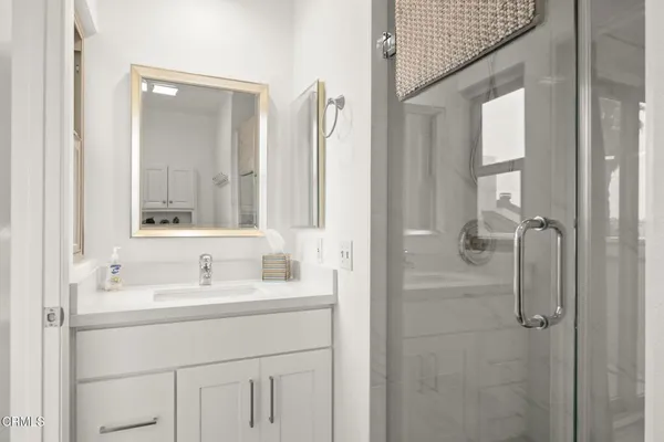 a bathroom with a sink vanity and mirror