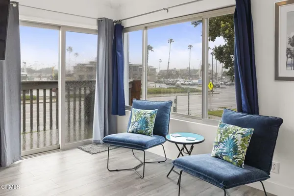 a view of a living room with furniture and a window