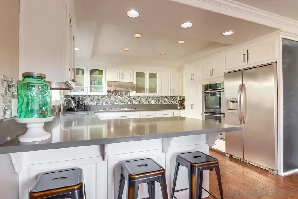 40 Bahama Bend Coronado, CA 92118 - Photo 12 of 36 a view of kitchen with stainless steel appliances granite countertop refrigerator sink and stove