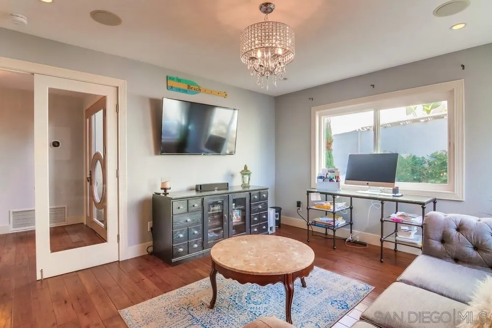 40 Bahama Bend Coronado, CA 92118 - Photo 15 of 36 a living room with furniture a dining table and a flat screen tv