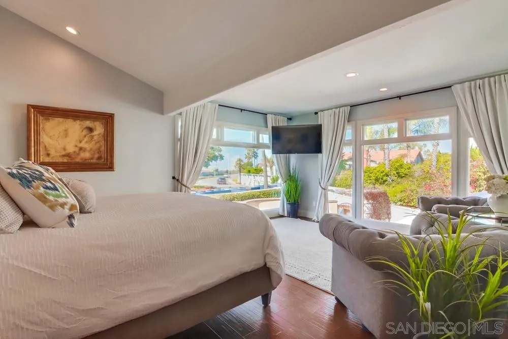 40 Bahama Bend Coronado, CA 92118 - Photo 18 of 36 a bedroom with a bed and large windows