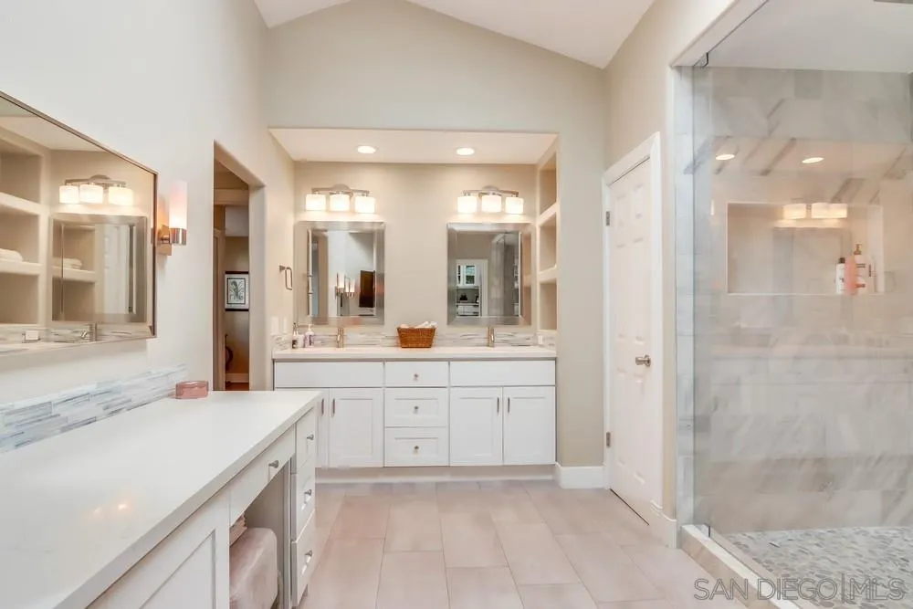 40 Bahama Bend Coronado, CA 92118 - Photo 21 of 36 a spacious bathroom with a shower sink and mirror