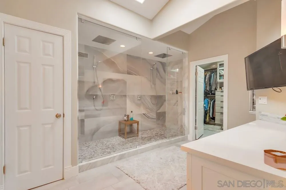 40 Bahama Bend Coronado, CA 92118 - Photo 22 of 36 a bathroom with a sink a mirror and shower
