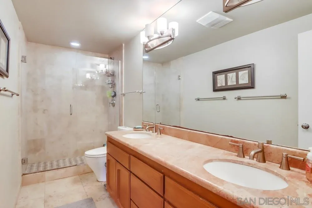 40 Bahama Bend Coronado, CA 92118 - Photo 28 of 36 a bathroom with a sink a toilet a shower and a mirror