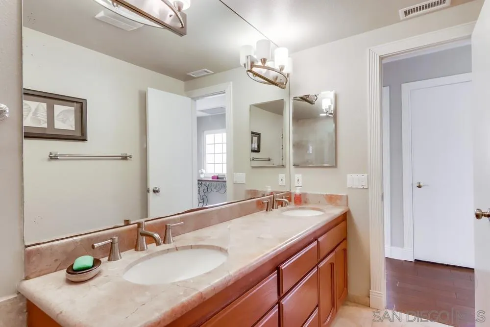 40 Bahama Bend Coronado, CA 92118 - Photo 29 of 36 a bathroom with a sink double vanity and a mirror