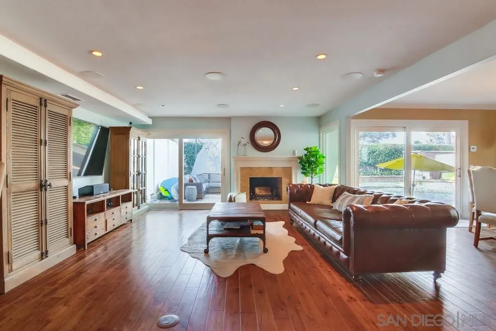 40 Bahama Bend Coronado, CA 92118 - Photo 4 of 36 a living room with fireplace furniture wooden floor and a large window