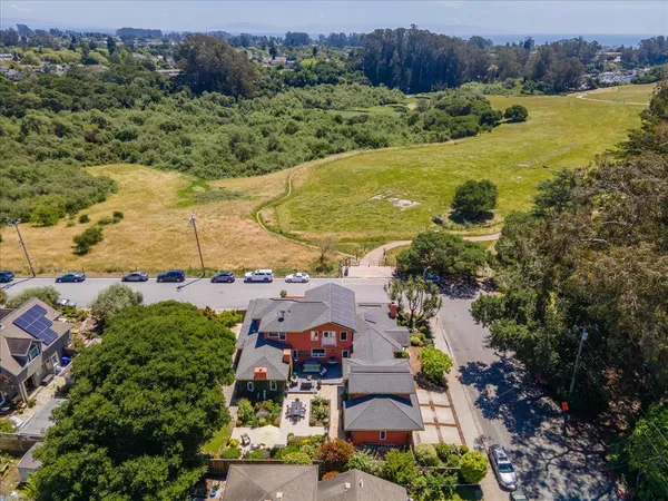 an aerial view of residential houses with outdoor space