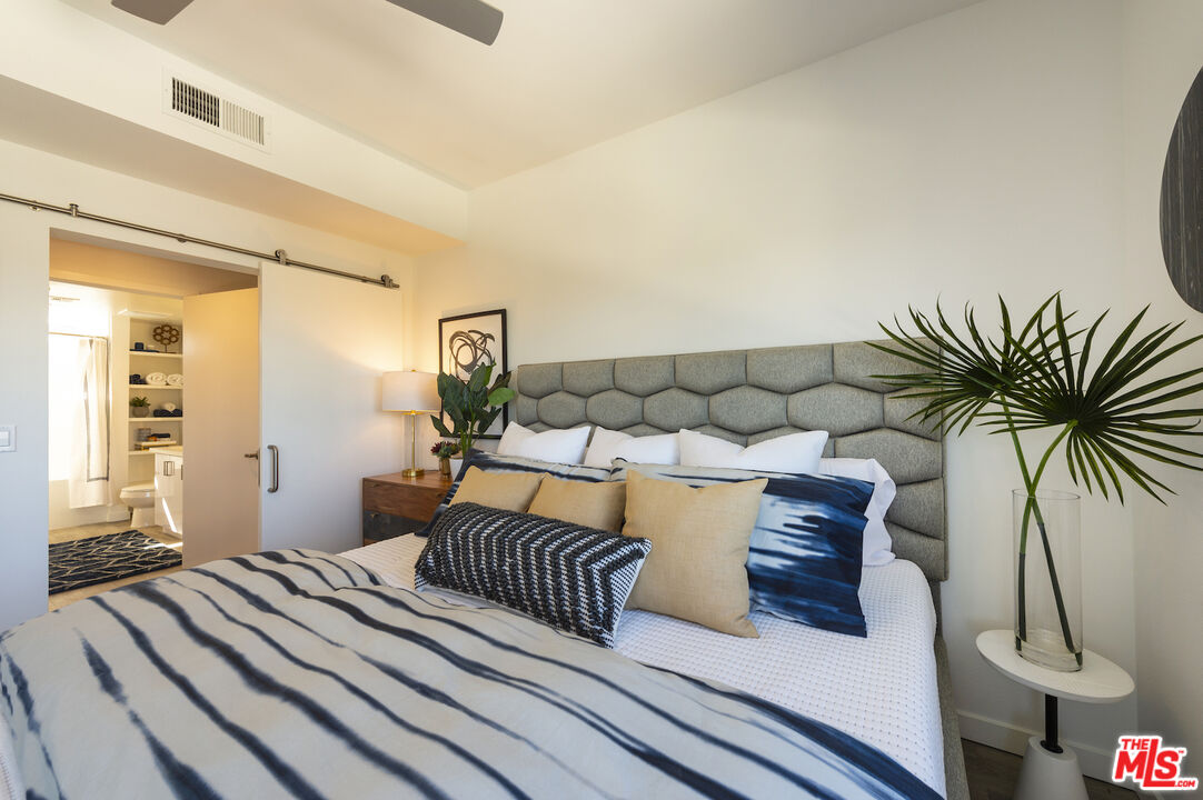 2929 Pennsylvania Avenue, Unit 111 Santa Monica, CA 90404 - Photo 21 of 28 a bedroom with a large bed and a potted plant