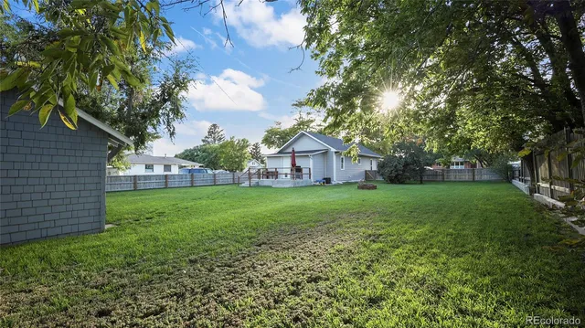 a view of house with backyard