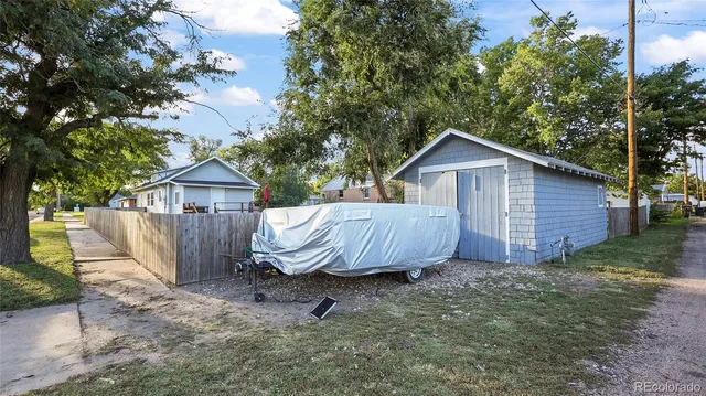 a view of a small house with a yard