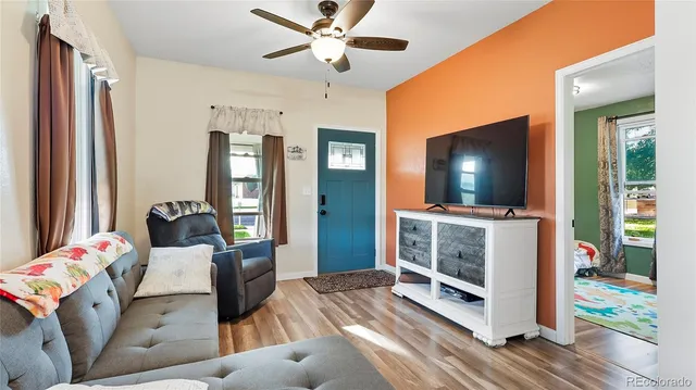 a living room with furniture and a flat screen tv