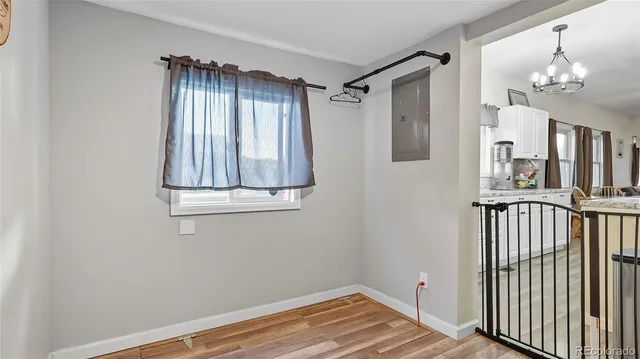 a view of a hallway with entryway and chandelier